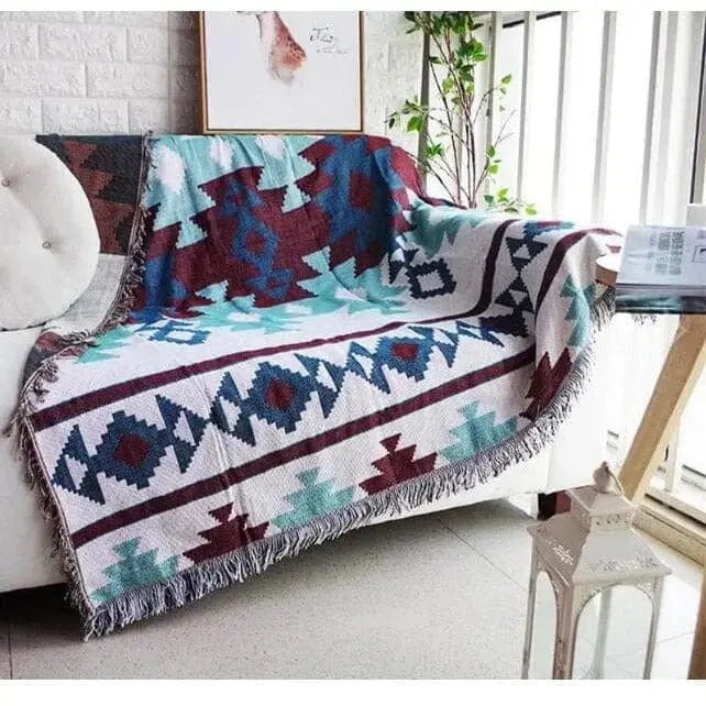 Plaid canapé ou housse extensible : jeté cosy posé sur un canapé